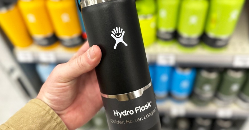 hand holding up a black hydro flask bottle in store