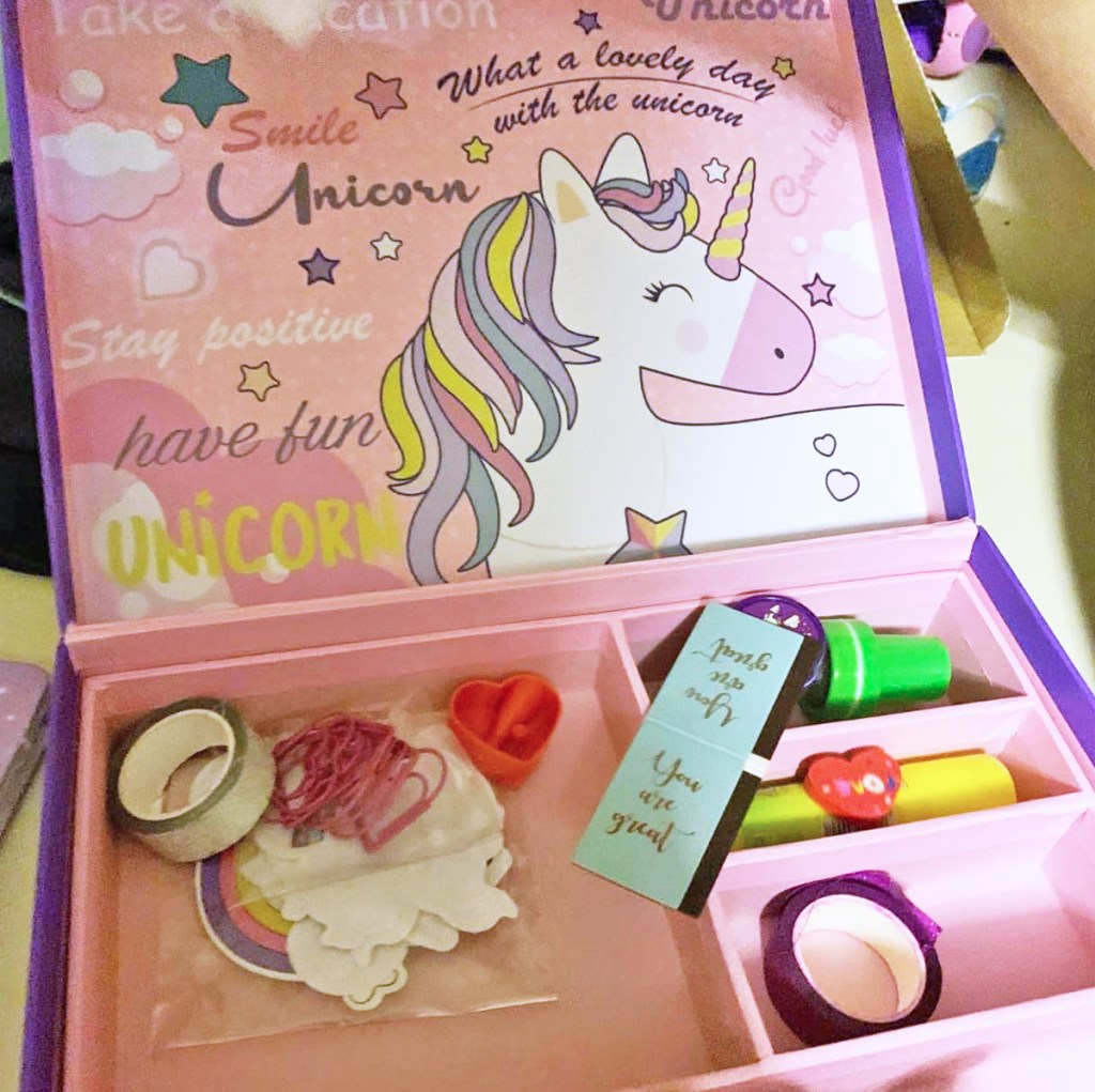 opened unicorn box with tape and stickers inside