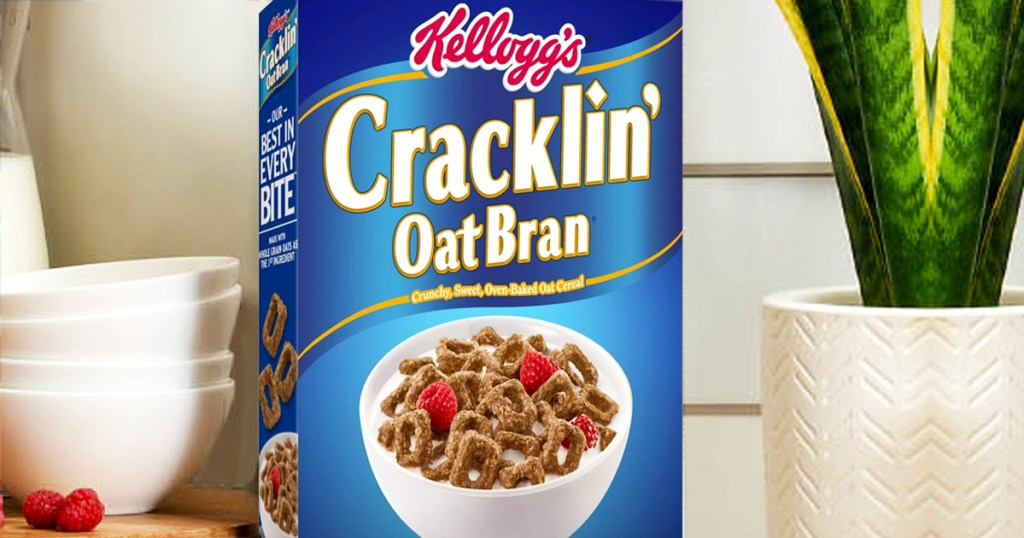blue box of Kellogg's Cracklin' Oat Bran Cereal near cereal bowls and potted plant
