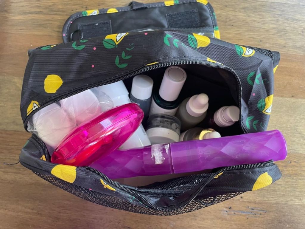 A toiletry bag opened with products in it 