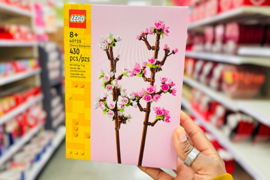 hand holding LEGO cherry blossoms in store