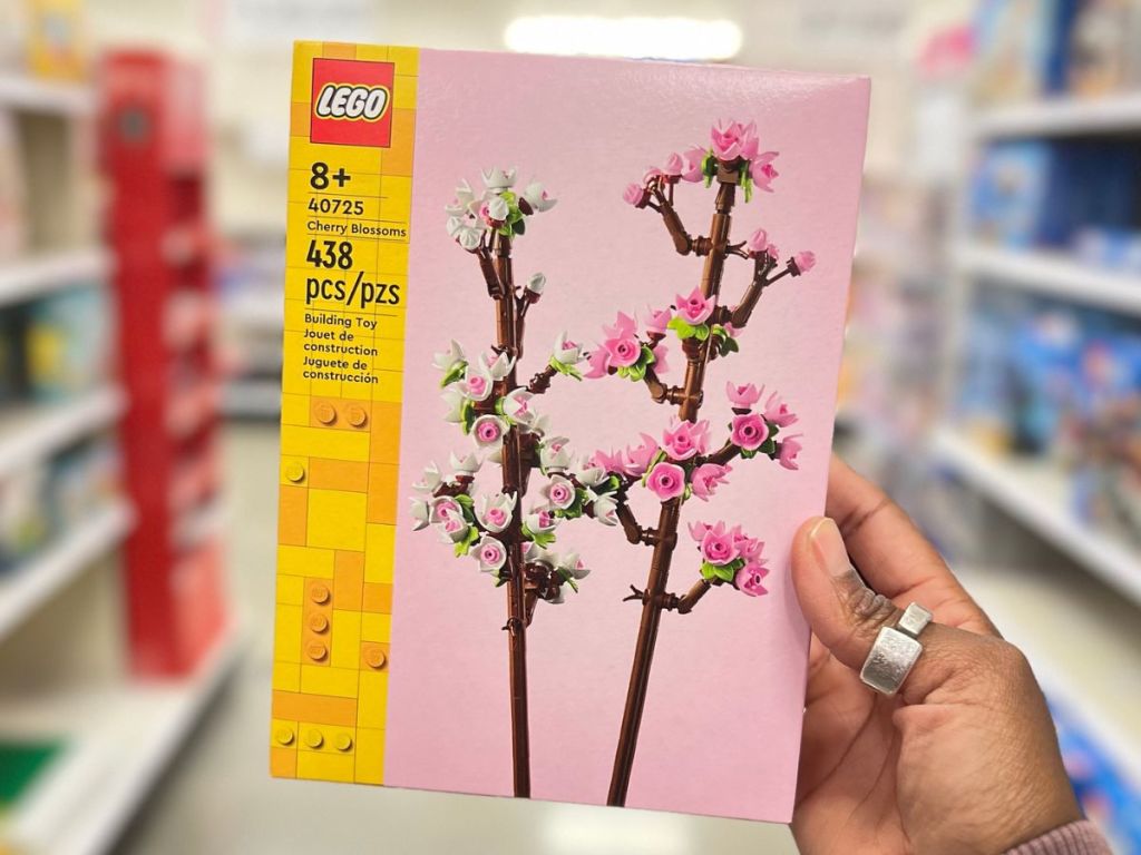 hand holding up a box of LEGO Cherry Blossom Flowers
