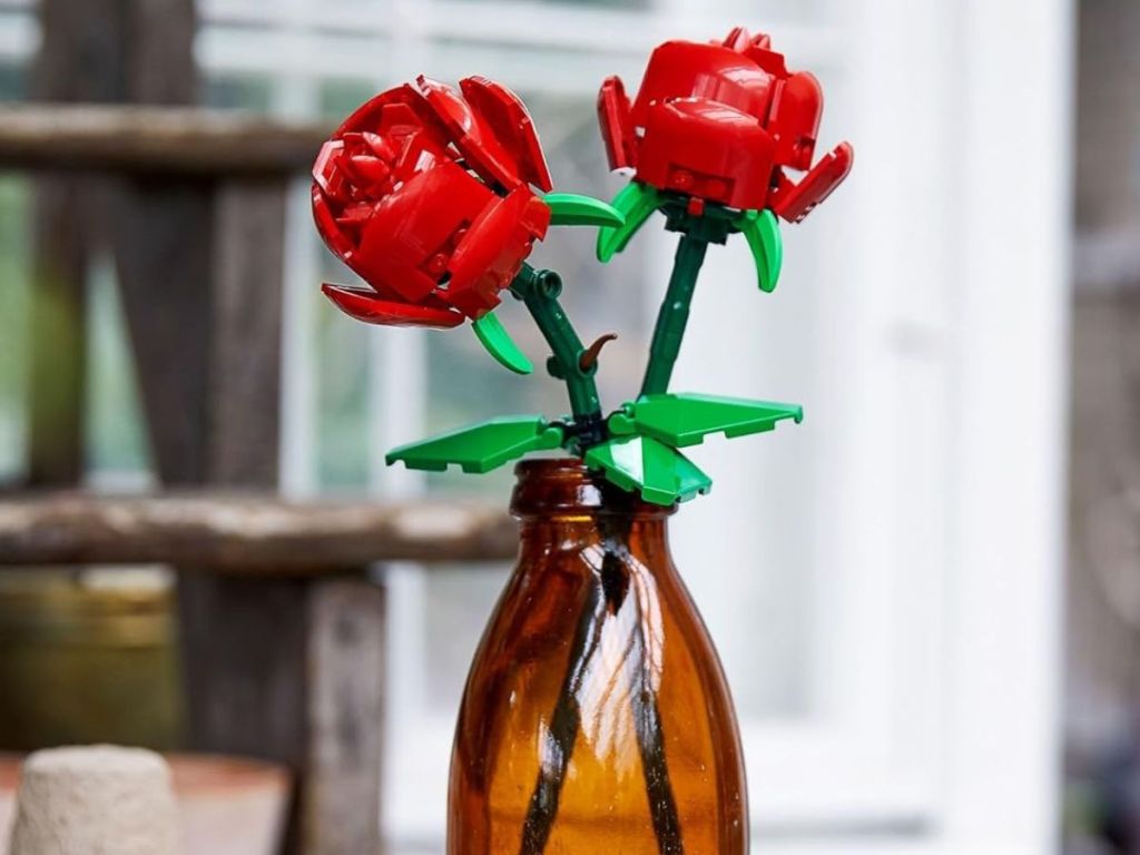 A vase with two LEGO roses in it