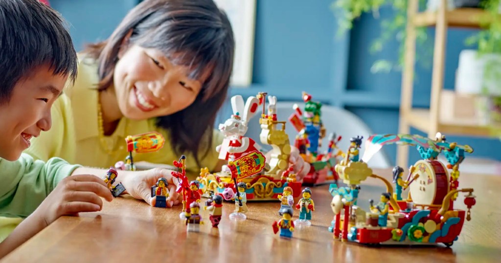 woman and child playing with lunar new year lego set 