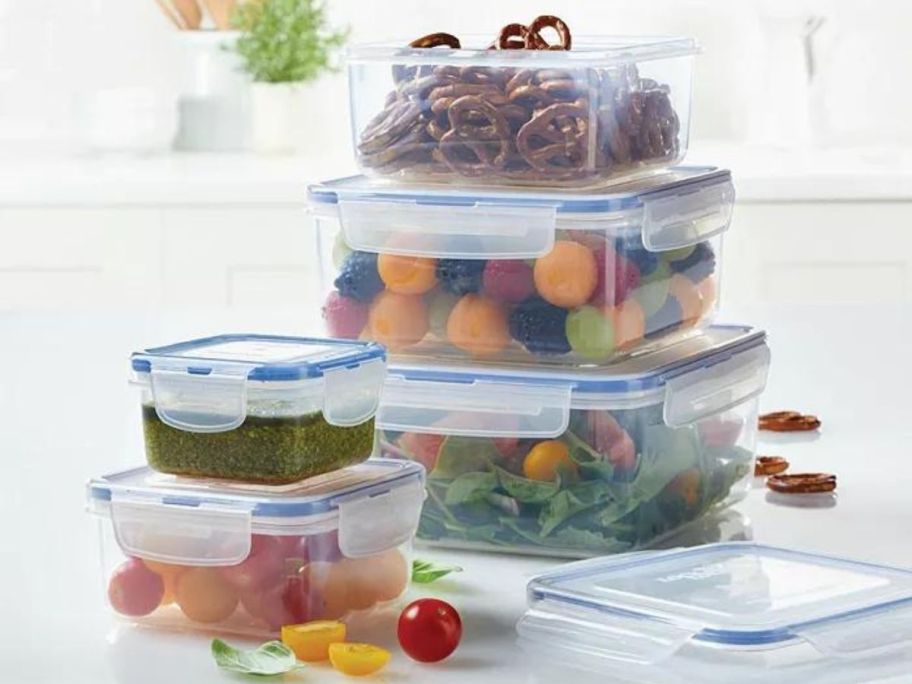 A 10-piece Lock n Lock Square nesting food storage set filled with various food items on a table