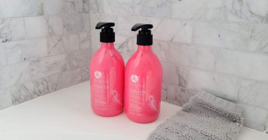 2 bottles of Luseta shampoo and conditioner on back of bath