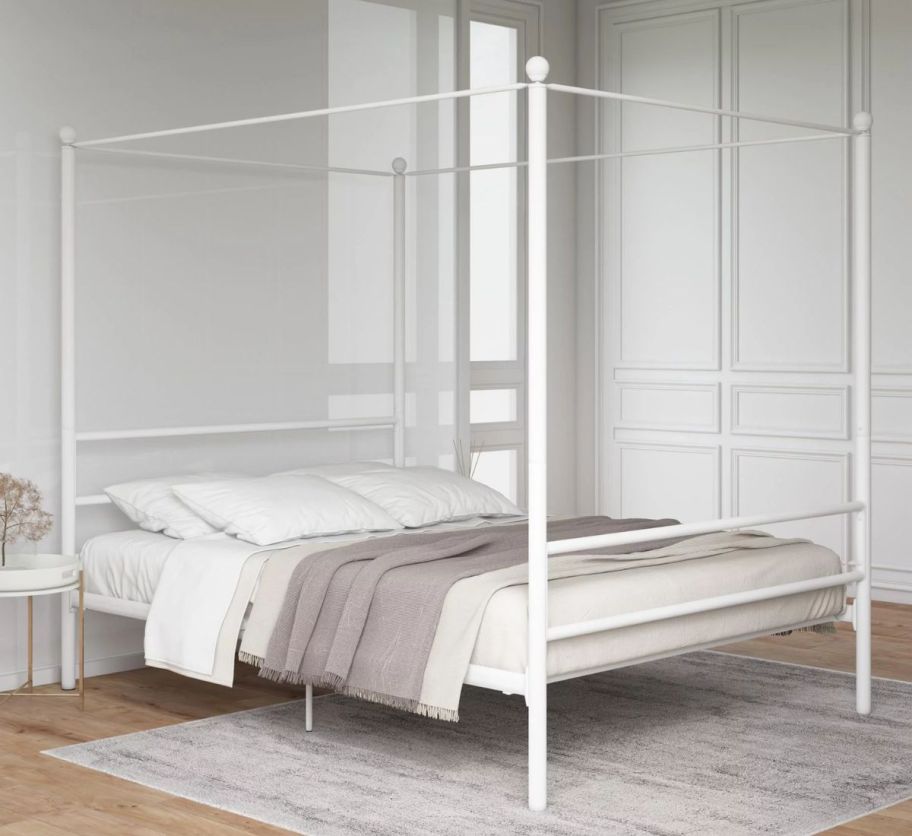 an off white metal canopy bed