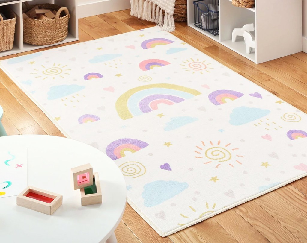 white rug with rainbow print on playroom floor