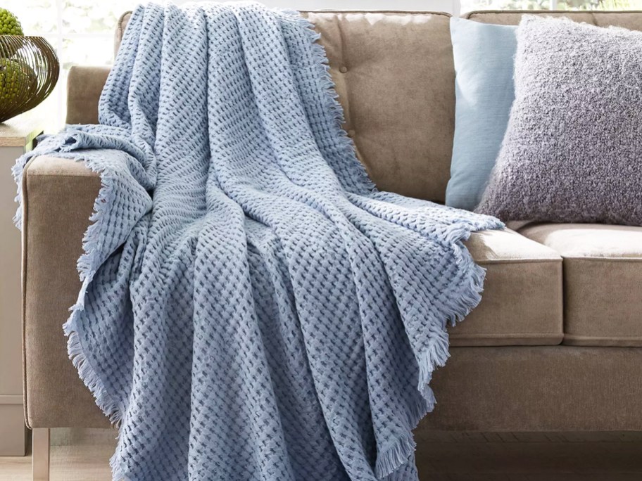 blue waffle knit throw draped over couch