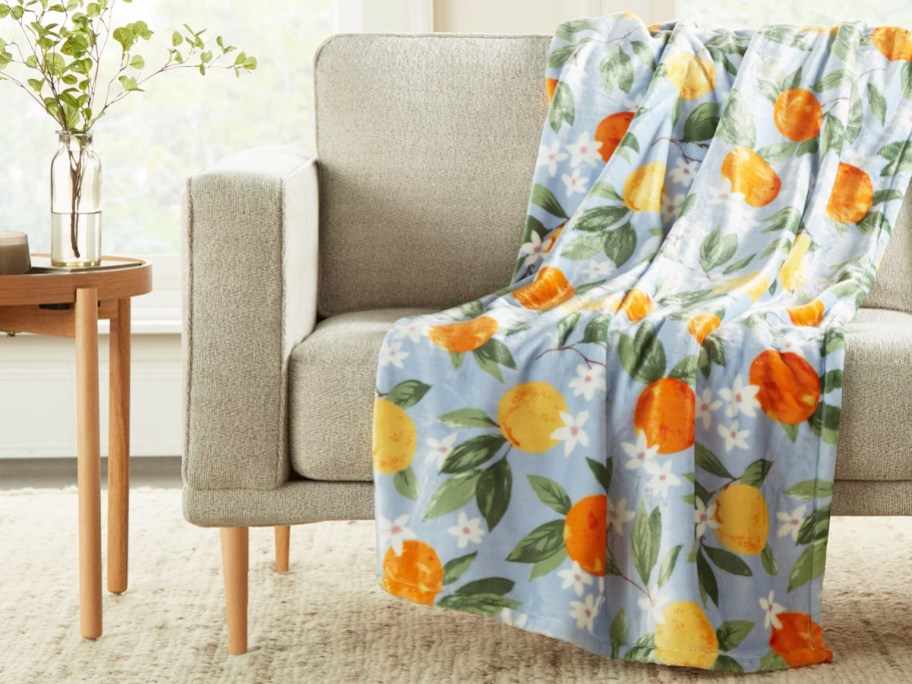 orange print throw blanket draped over couch