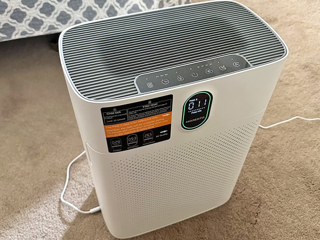 white air purifier on floor in bedroom