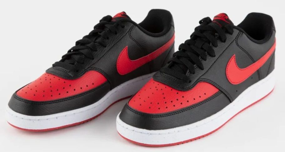 a pair of red and black nike court vision shoes