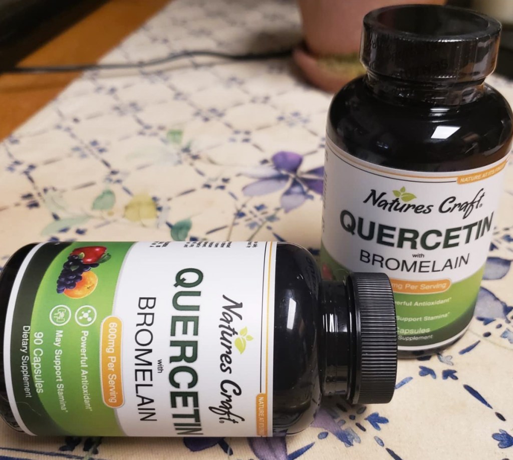 two bottles of Nature's Craft Quercetin on table with one laying on its side