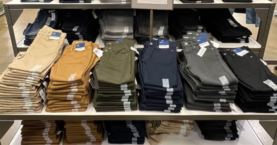 A table filled with folded Old Navy pants in different colors