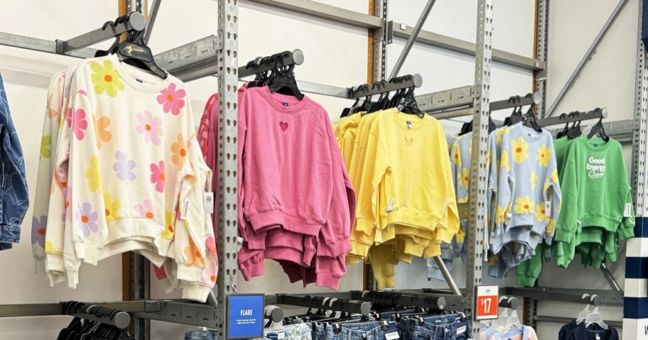 row of girls sweatshirts on display in store