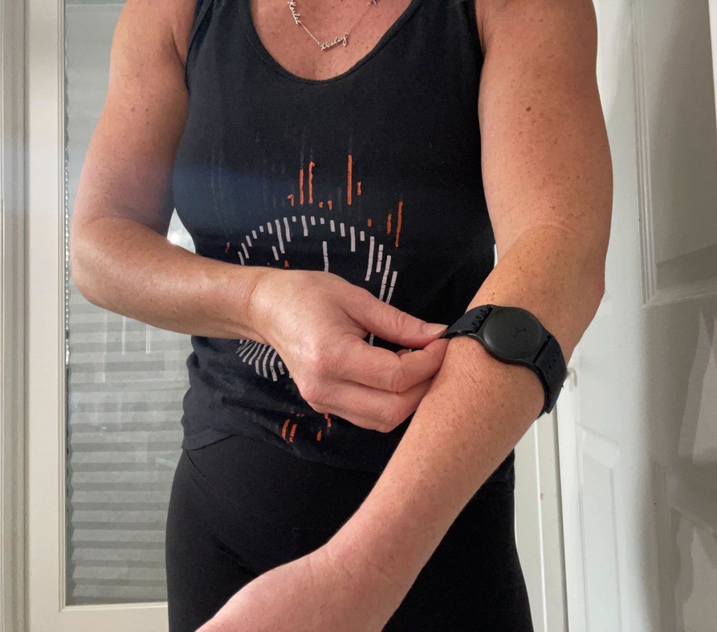 Erica wearing the Orange Theory Fitness heart monitor armband