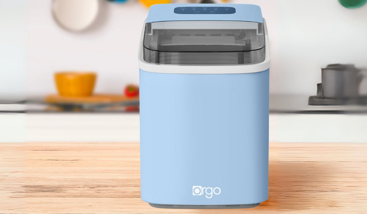 a blue Orgo Sierra Countertop Ice Maker sitting on a butcherblock counter in a kitchen