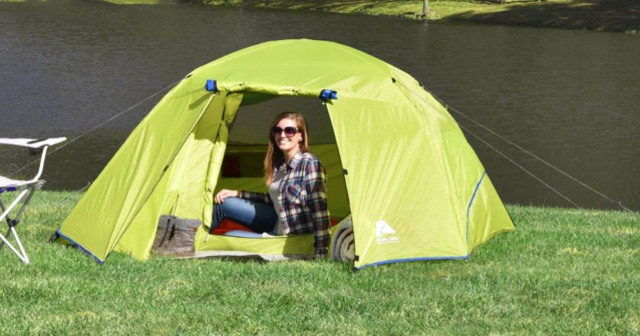 A woman sitting in an Ozark Trail 4-Person Dome Tent