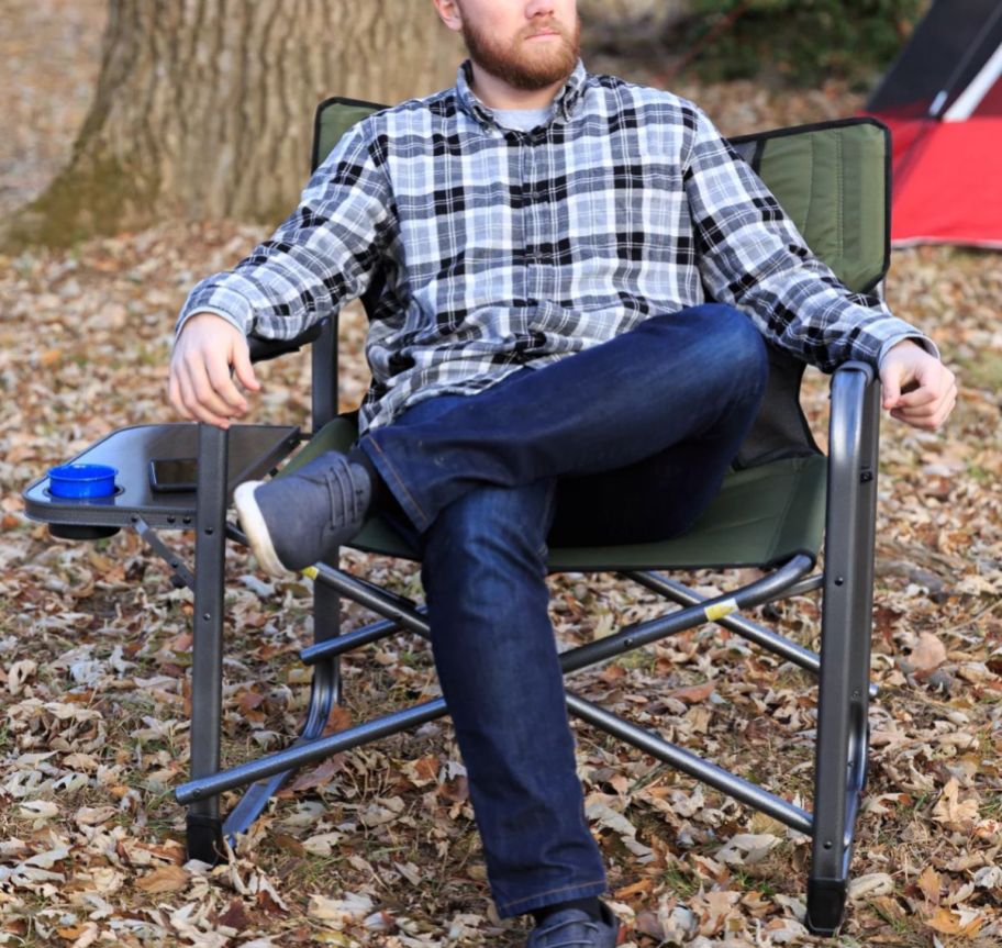 a man sitting in a green camping chair
