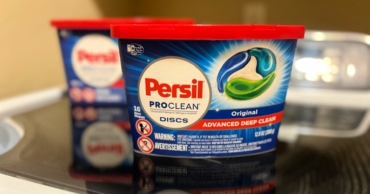 Different sized containers of persil laundry detergent on top of washing machine