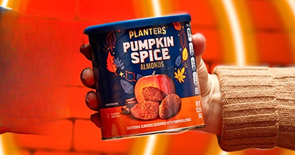 hand holding up Planters Pumpkin Spice Almonds 15.25oz Can