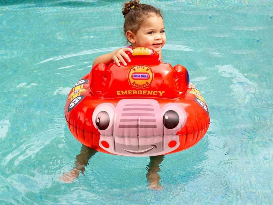 A child in a fire truck pool float