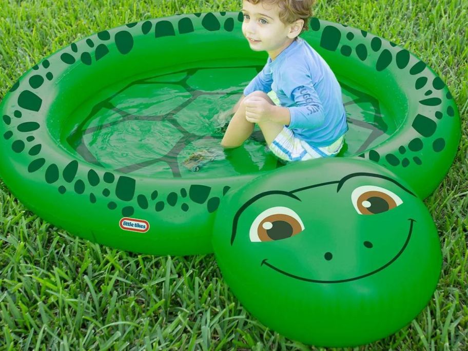 a child in an inflatable turtle pool