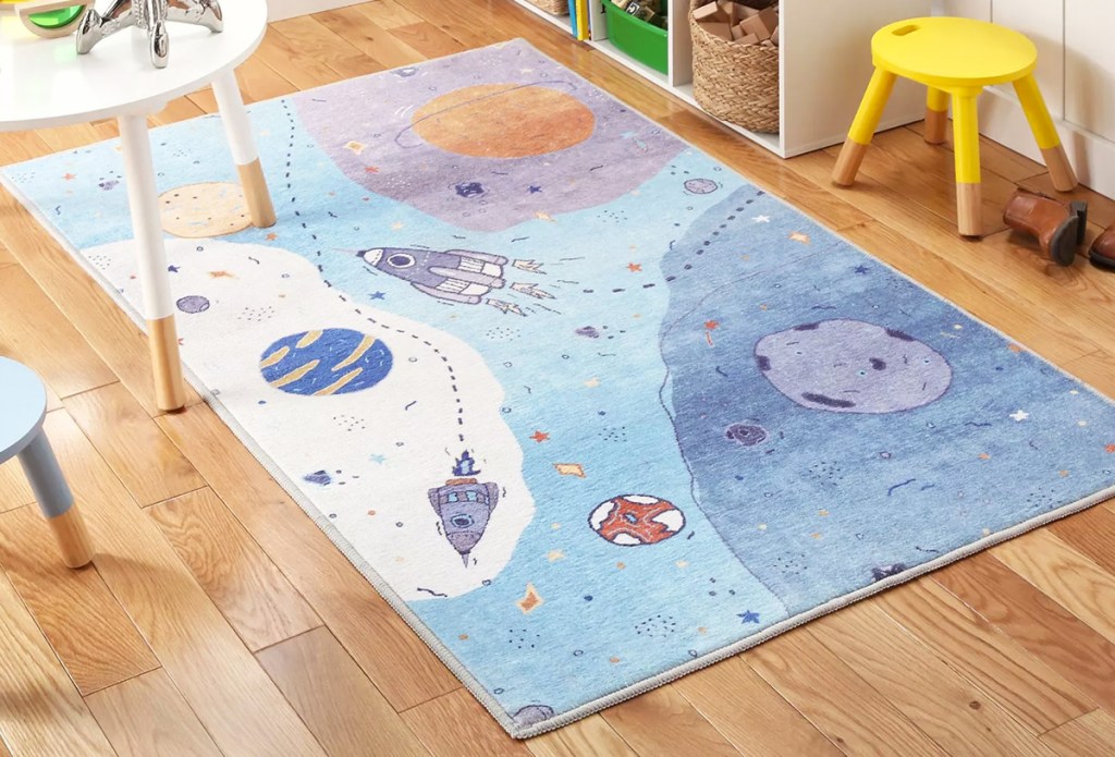space ship print rug on playroom floor