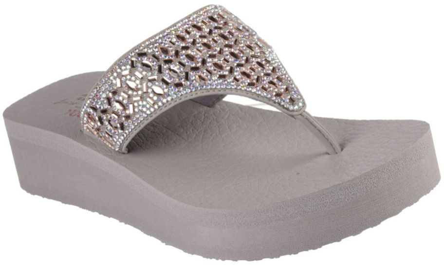a taupe colored wedge throng flip flop with sparkly accents