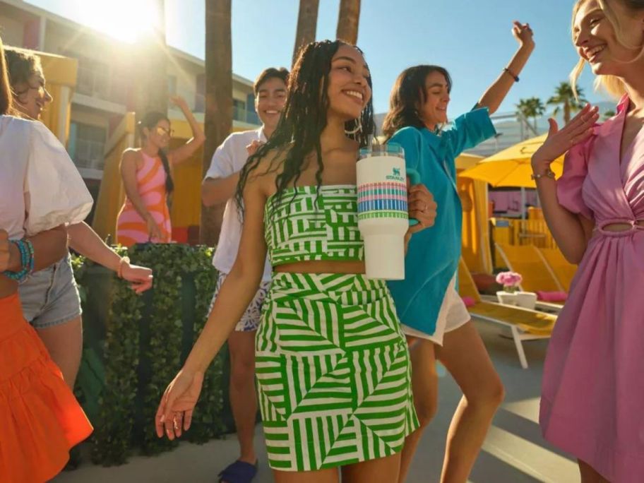 woman walking with summer plaid Stanley tumbler