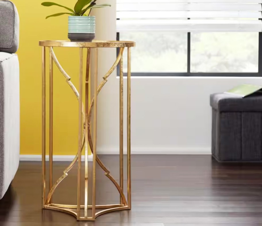 gold accent table with potted plant on top