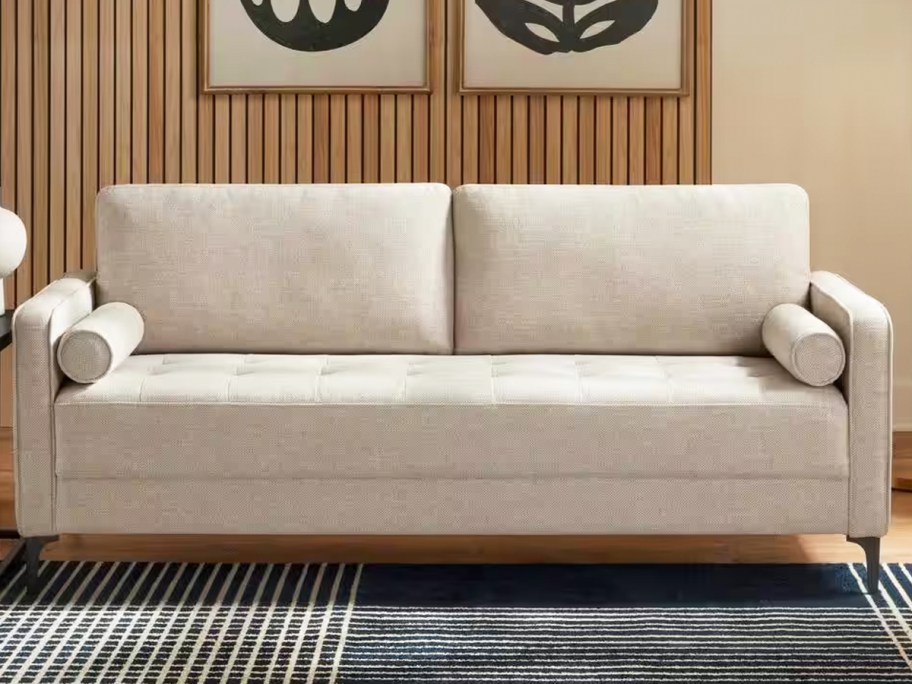 beige linen sofa with bolster throw pillows in living room