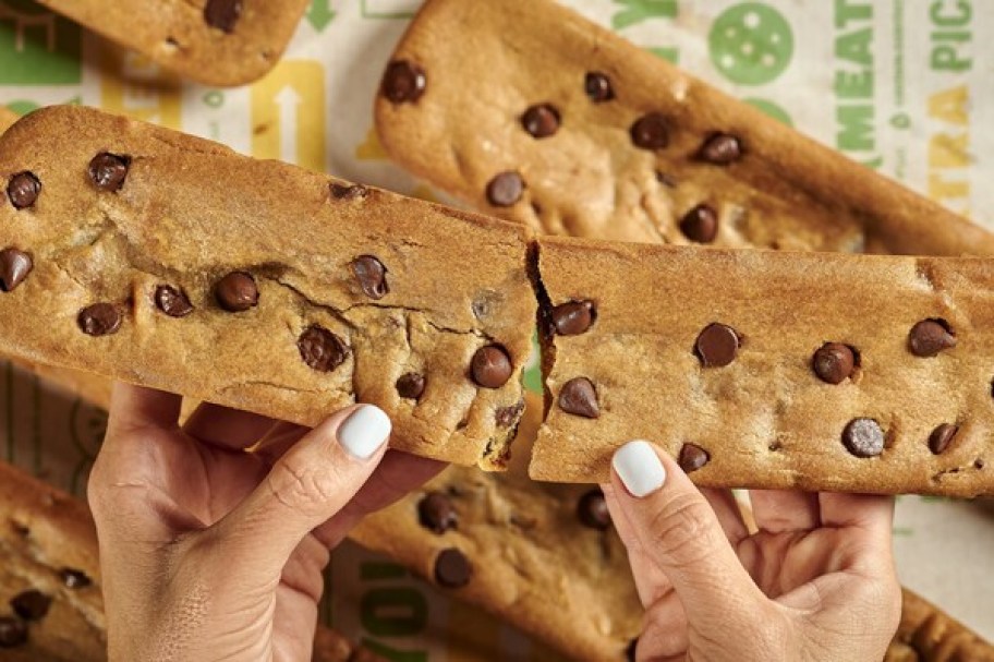 hands holding a Subway Footlong Cookie