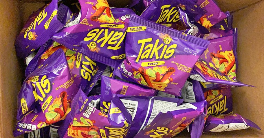 box full of purple bags of Takis Fuego chips