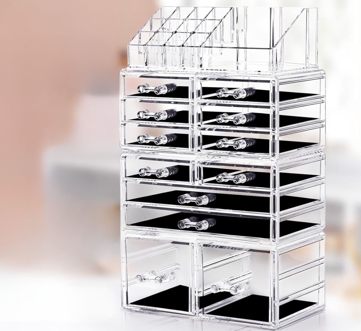 a 4 piece clear acrylic makeup organizer with black velvet drawer liners.