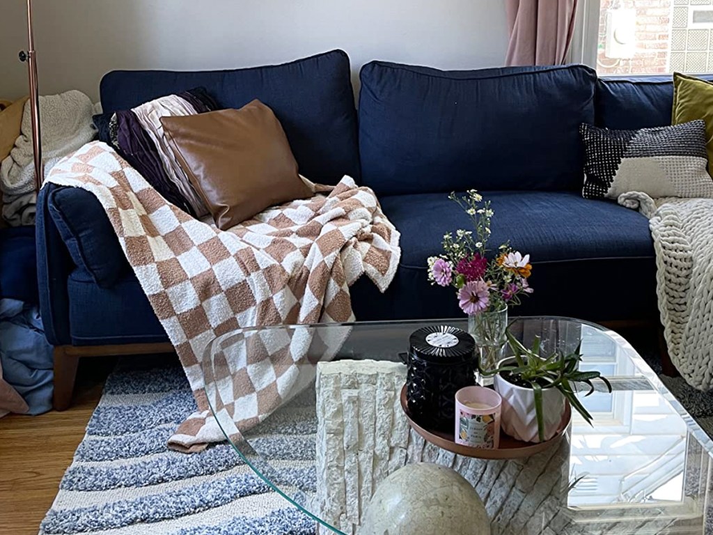 checkered throw blanket draped on blue couch