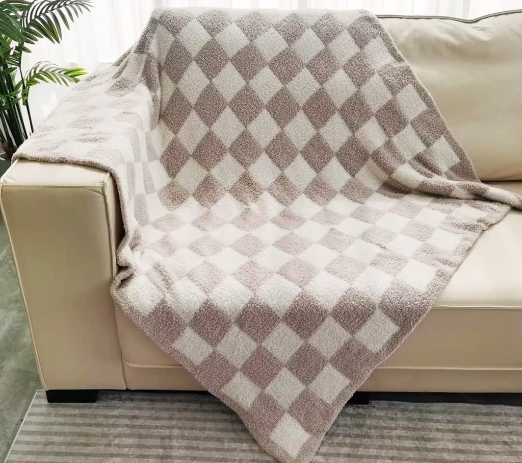 tan and white fuzzy checkered throw blanket draped on couch