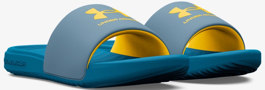 pair of blue and yellow under armour slides