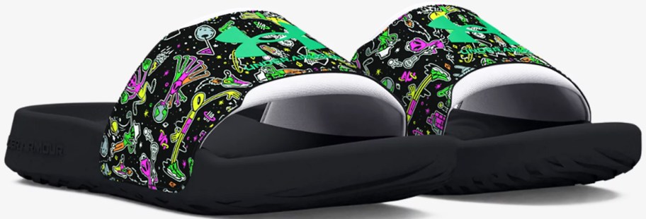 black, green, and purple alien print under armour slides