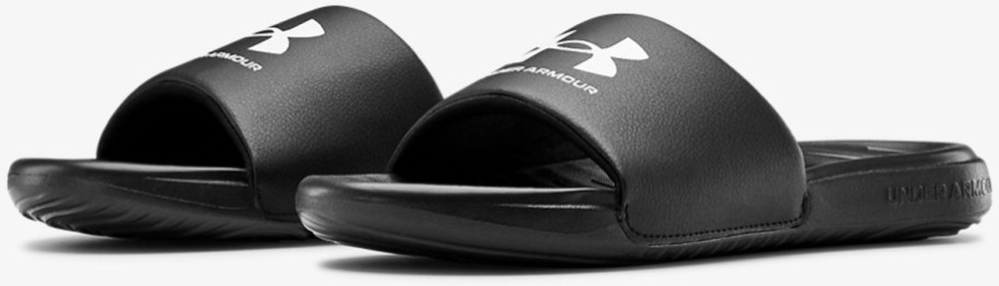pair of black and white under armour slides