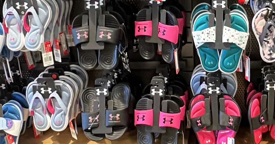 under armour slides in various colors on display in store