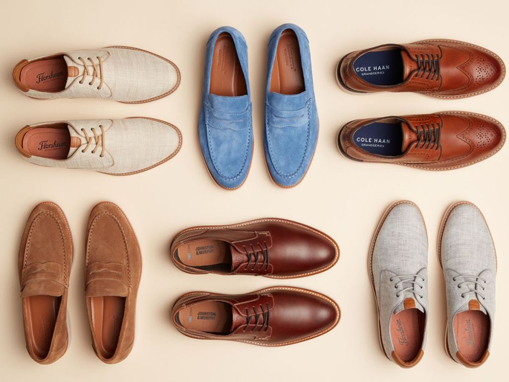 several pairs of men's dress shoes laid out including loafers, dress shoes