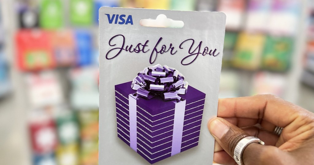 hand holding up a visa gift card