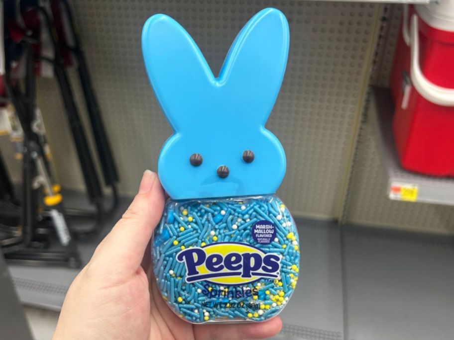 Hand holding a container of Peeps Sprinkles