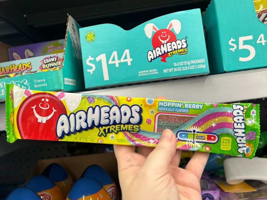 Hand holding up a pack of Airheads Easter Candy