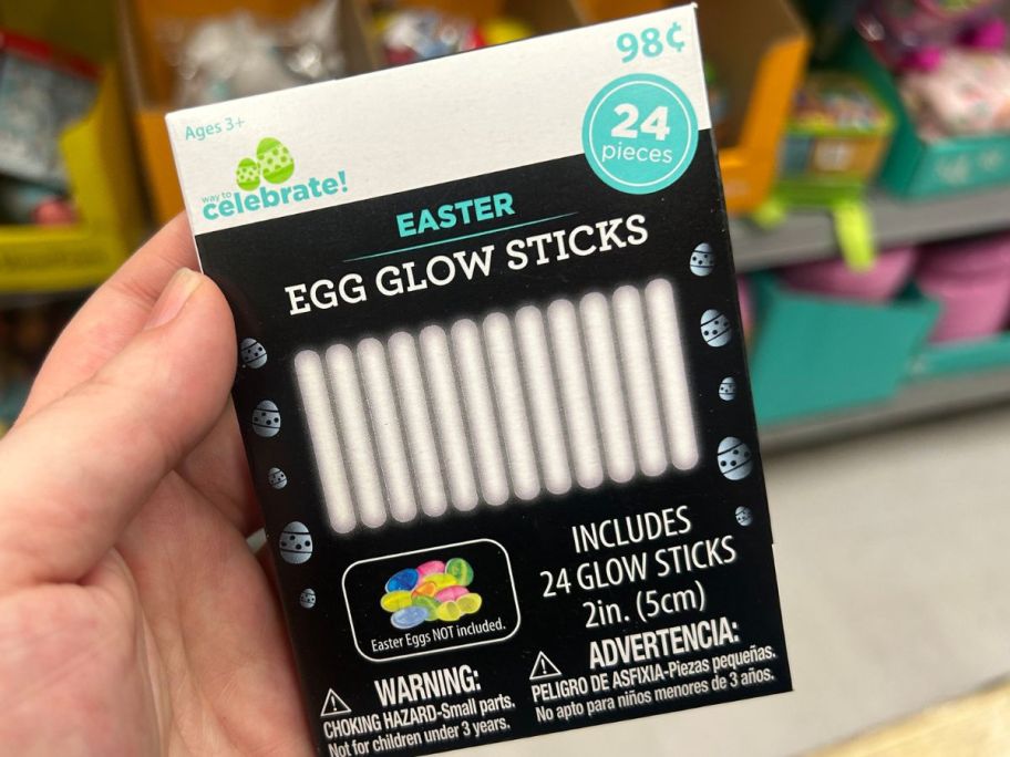 Hand holding a pack of Egg Glow Sticks 