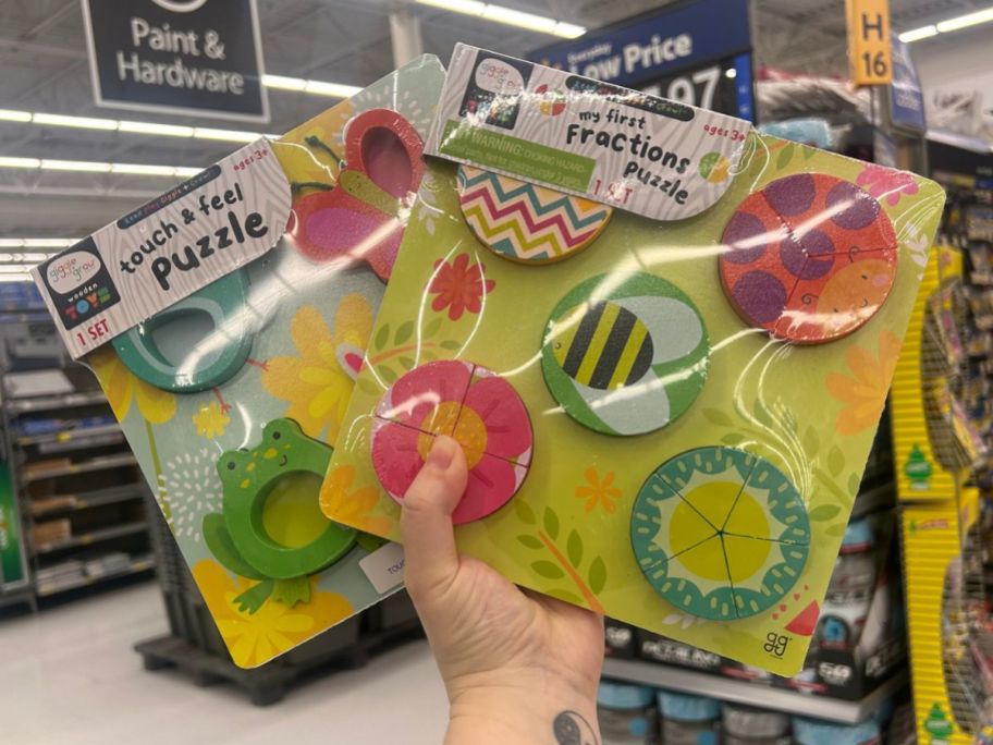 Hand holding up 2 Mini Easter Puzzles at Walmart