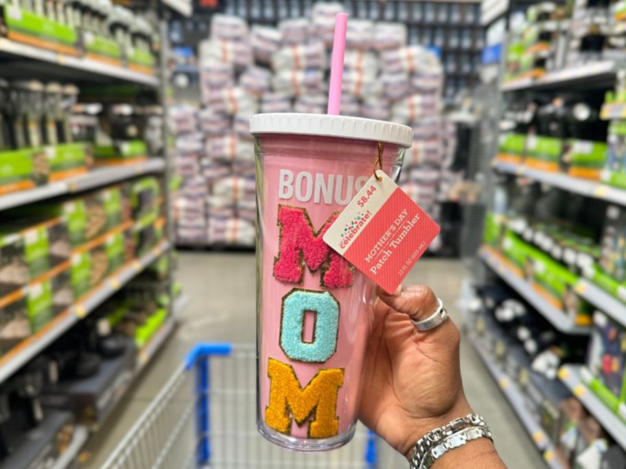 A hand holding a Way to Celebrate Mother's Day Tumbler Bonus Mom
