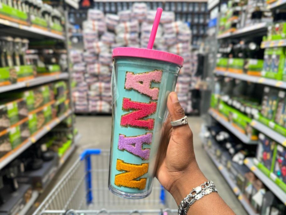 A hand holding a Way to Celebrate Mother's Day Tumbler Nana