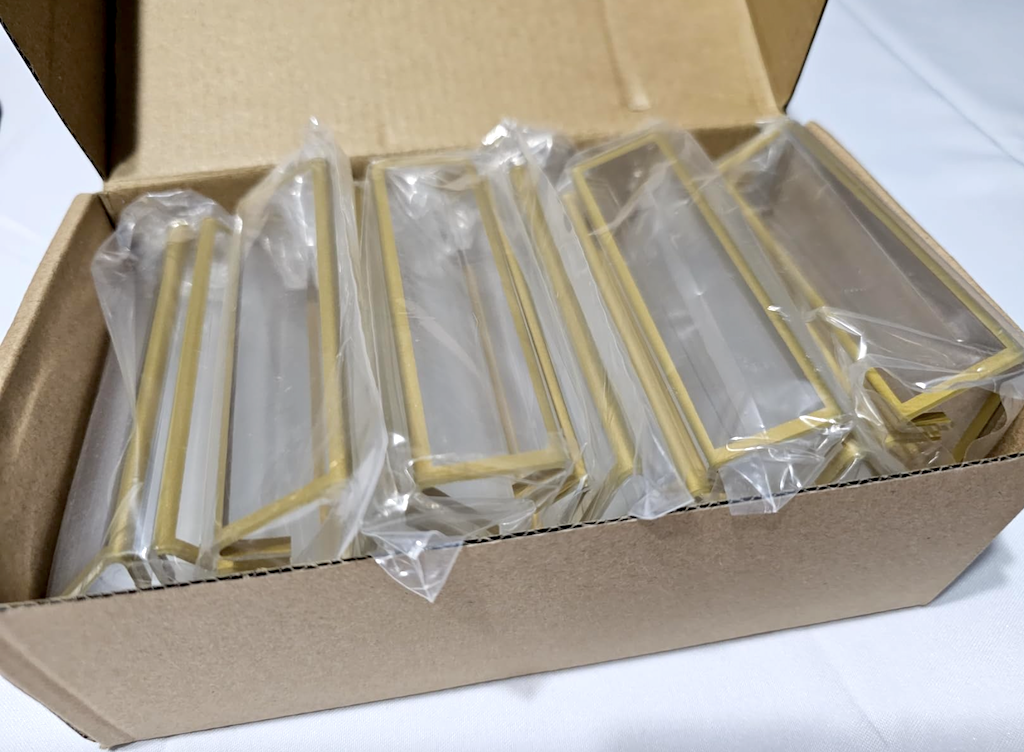 acrylic and gold picture frames in box 